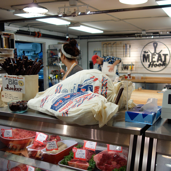 The meat counter at The Meat Hook, where you can see butchers dressing the meat.