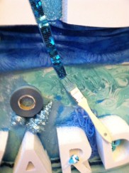 Painter's tape, sparkly braid and bating brush.